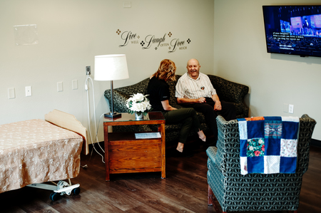 Elderly man with women sitting on a sofa